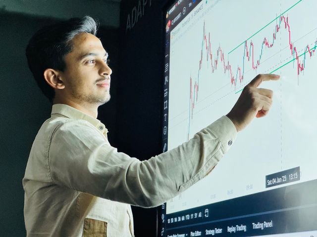 Focused trader at a desk with charts
